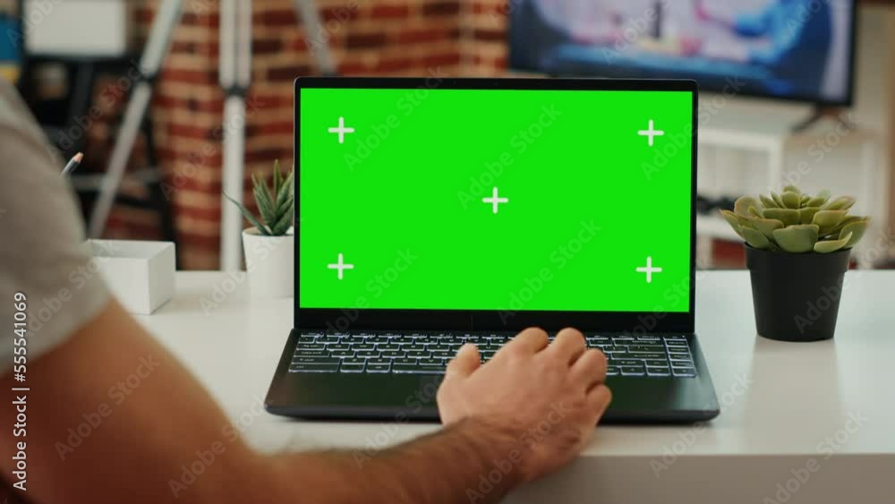 Poster man using wireless pc with isolated greenscreen display, working on software with chroma key mockup 