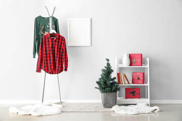 Interior of room with pajamas, Christmas tree and gifts