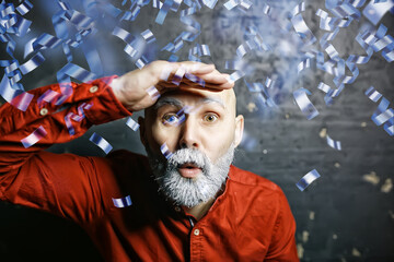 man portrait greeting new year and christmas falling flying confetti