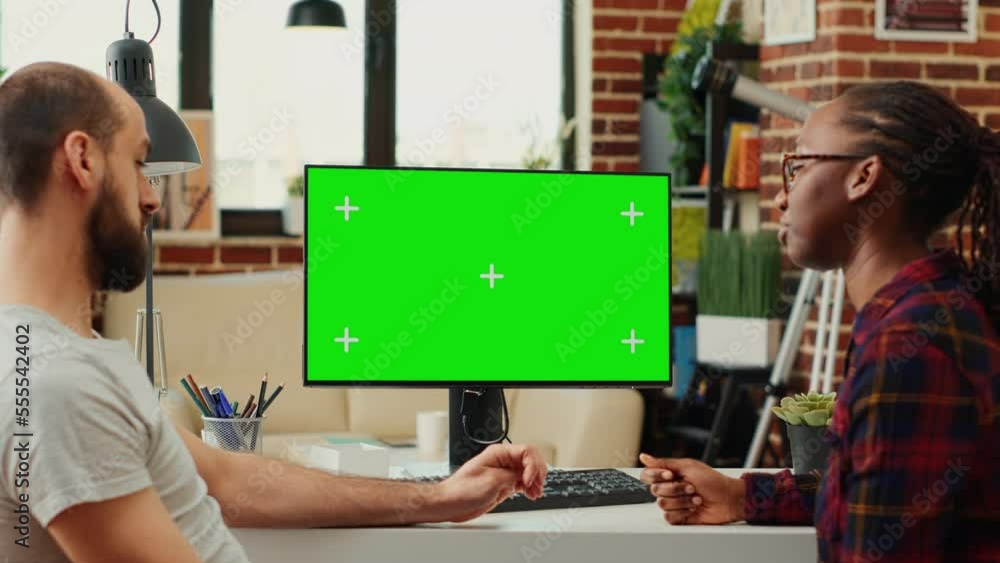 Poster multiethnic team of people looking at computer with greenscreen, analyzing chroma key display on mon