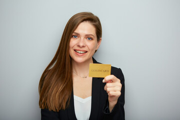 Young woman holding credit card, black suit. Isolated female portrait.