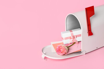 Mailbox with letters, gift and rose on pink background. Valentine's Day celebration