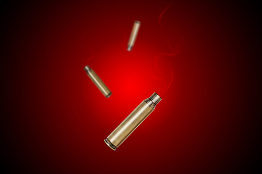 Smoking bullet assault rifle 5.56 casing shell fired out of a handgun falling down