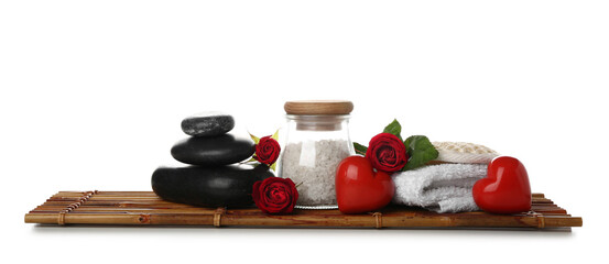 Spa composition for Valentine's Day with stones, roses and hearts on white background