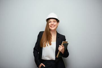 Smiling woman teacher engineer profession holding book.