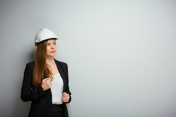 Woman builder in black business suit isolated portrait.