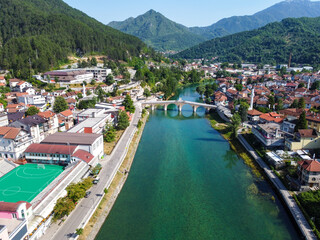 Old stone bridge over the Neretva river, Konjic, Bosnia and Herzegovina. Aerial drone view of city. 
