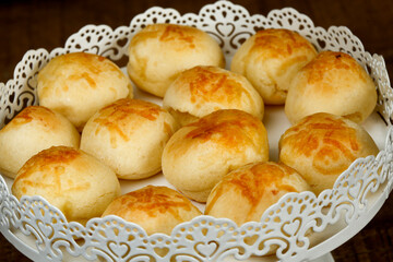 Portion of traditional Brazilian cheese bread on white tray
