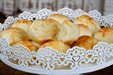 Portion of traditional Brazilian cheese bread on white tray