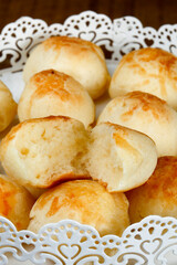 Portion of traditional Brazilian cheese bread on white tray