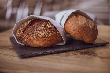 Fresh bread in a paper bag on a wooden table. The concept of natural products. gluten free bread.