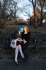 unconventional lesbian couple embracing in urban park