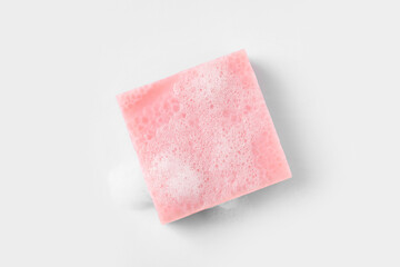 Soap with fluffy foam on white background, top view