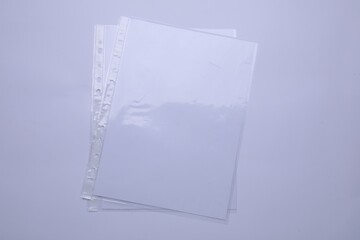 Punched pockets with paper sheets isolated on white, top view