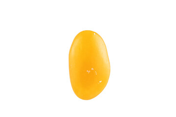 Yellow oval candy on a white background.