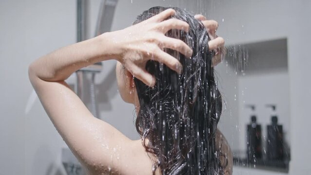 Taking a shower and washing the woman's hair is also cute. angle from behind taking