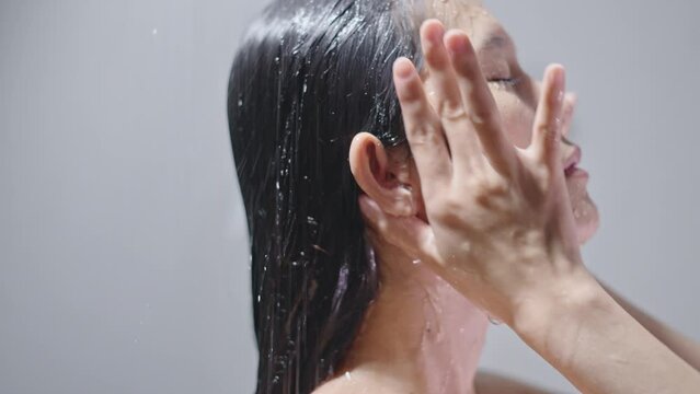She takes a shower and uses shampoo like an Asian woman.