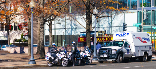 Police officers on motorcycles are on duty on the side of Washington Street. Autumn weekend in the...