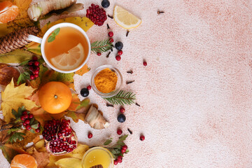 Flat lay composition with cup of delicious immunity boosting tea and ingredients on color textured background. Space for text