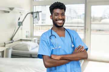 Laughing african american young doctor or male nurse at hospital room