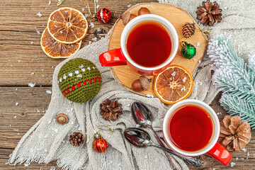 Winter cozy composition with hot tea and traditional Christmas decoration. New Year balls