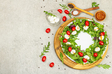 Charcuterie wreath made with mozzarella, cherry tomato, arugula. Fashionable snack, vegetarian food