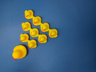 A group of ducks and their chicks are on a blue background.