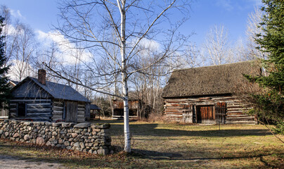 Fototapeta na wymiar Old log buildings homestead in field