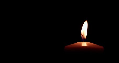 Candle Flame with Alpha Channel. The candle burns with a soft yellow flame. Candlelight, isolated. Close-up, slow motion. Candle lit on transparent background. Life, remembrance, or celebration.