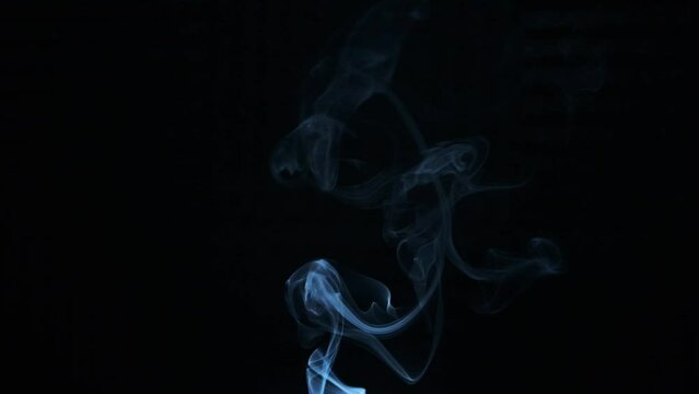 Smoke going up in slowmotion on a black background