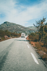 Obraz premium Empty road leading towards mountains on a moody autumn day in Norway.