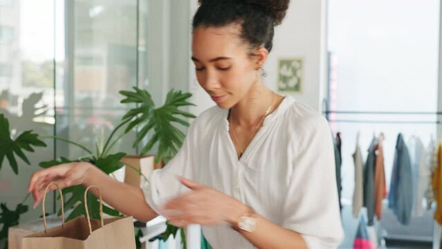 Ecommerce, small business and woman packing order in shopping bag for delivery. Online shopping, retail fashion stock and logistics, black woman designer or startup owner with package for transport.
