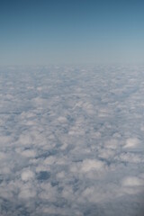 Fototapeta na wymiar Clouds outside airplane window