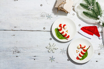 Caprese salad in form of a Christmas candy cane. Traditional New Year design, festive decoration