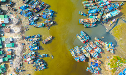 La Gi fishing village seen from above with hundreds of boats anchored along both sides of river to avoid storms near estuary, this is also a large fishing port providing seafood in central Vietnam
