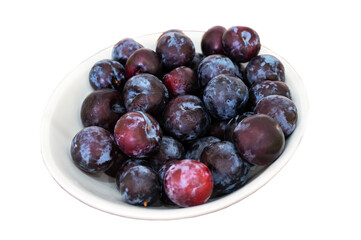 Plum. Lots of fresh, mouth-watering fruits are on a white plate. The concept of healthy, child food, vegetarianism. isolated