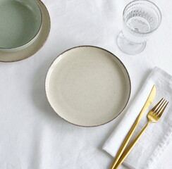 Plate mockup, empty modern minimal table place setting neutral beige color top view.  Space for...
