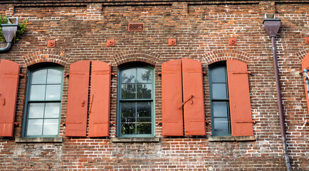 Old Red and Brown Brick ??Building with Arched Victorian Style Windows.