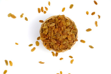 Yellow Raisins in bamboo bowl isolated on white background.
