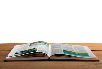 Open book or magazine on a wooden desk