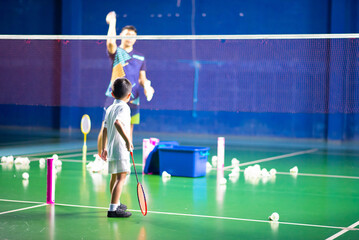 Boys training badminton indoor  activitiy