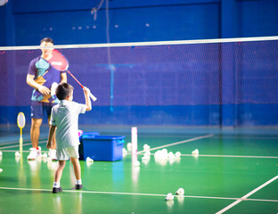 Boys training badminton indoor  activitiy