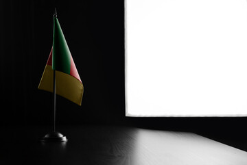 Small national flag of the Cameroon on a black background