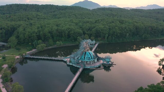 Aerial of rundown Ho Thuy Tien abandoned water park with huge dragon structure and empty lake in Hue, Vietnam.
