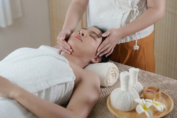 Young woman doing relaxing massage in spa salon. Female being massaged by a masseur. Spa and medicine concept