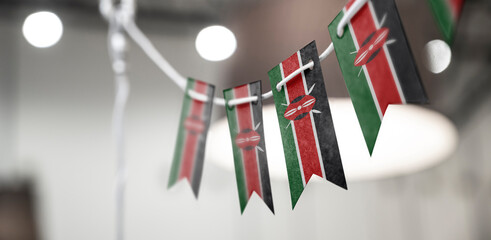 A garland of Kenya national flags on an abstract blurred background