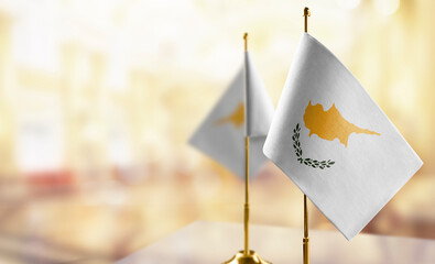 Small flags of the Cyprus on an abstract blurry background