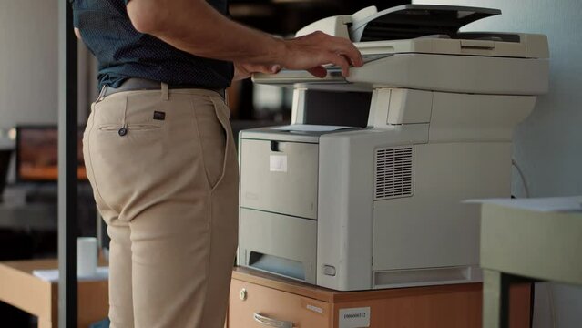 businessman printing document on printer . assistant using multifunctional copier