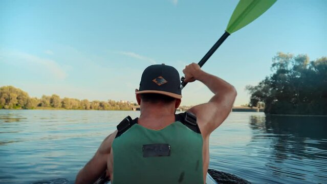 sportsman with oar rowing on canoe . sportsman with paddle on kayak