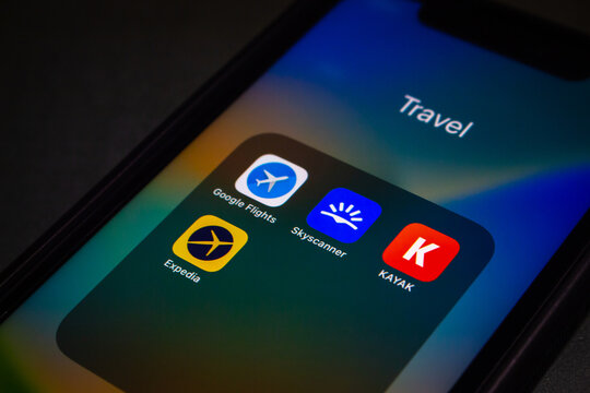 Vancouver, CANADA - Dec 9 2022 : Google Flights, Skyscanner, KAYAK and Expedia icons seen in iPhone screen. An online flight booking search service and travel technology concept